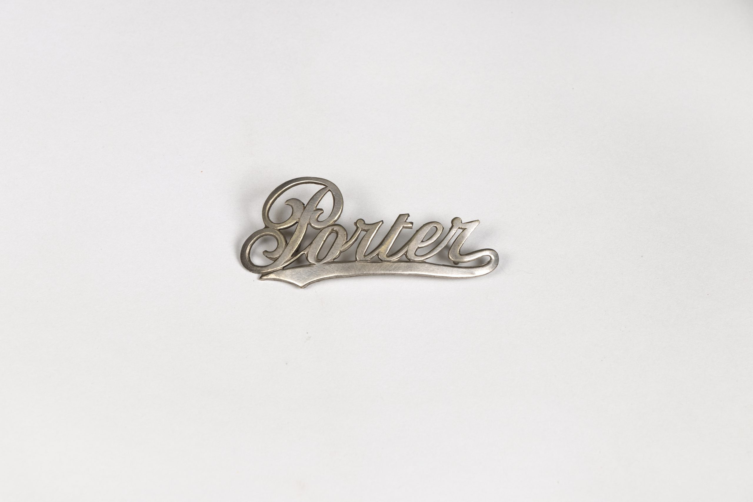 silver badge which reads Porter