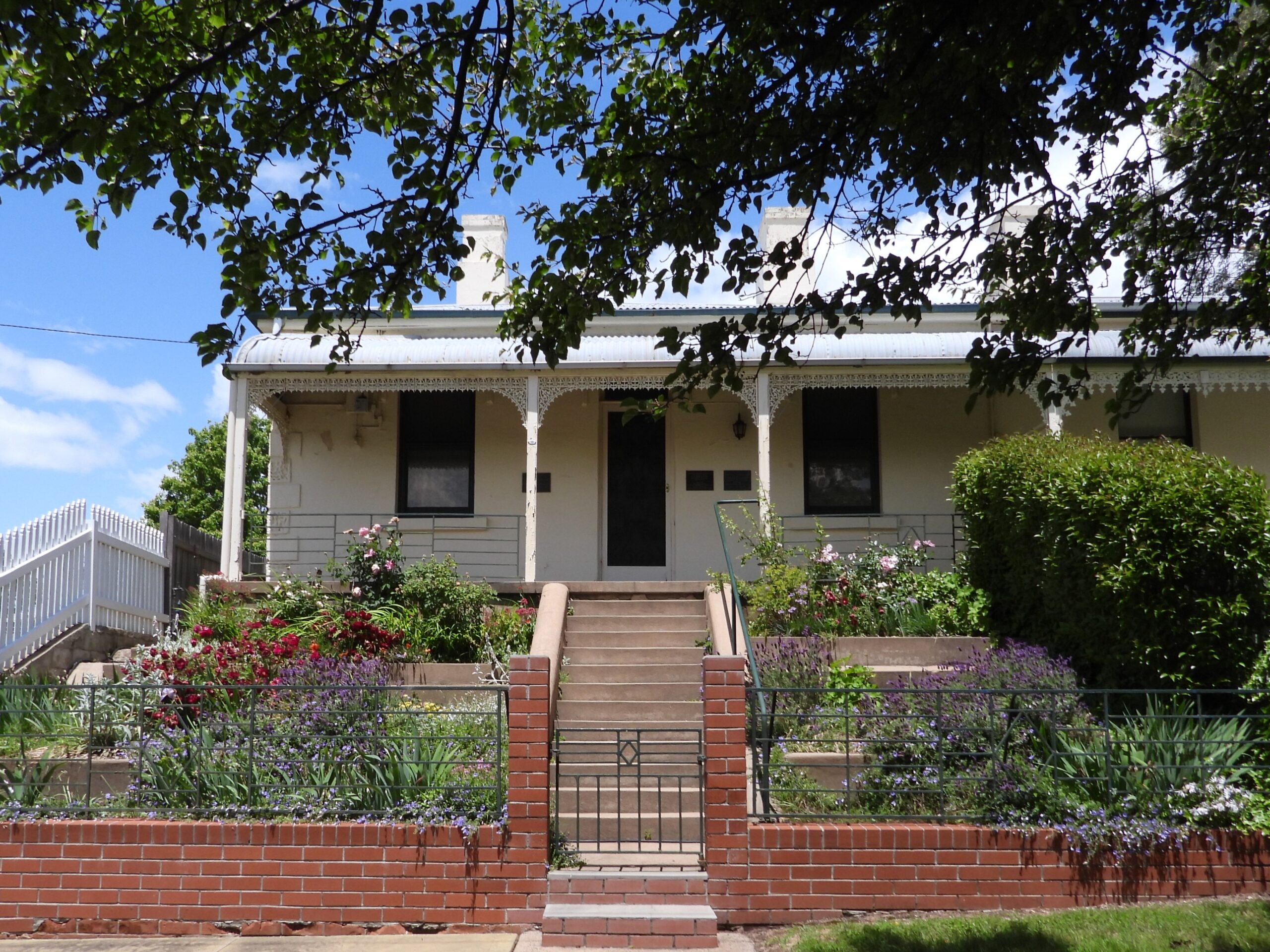 outside of a suburban home with well-manicured garden