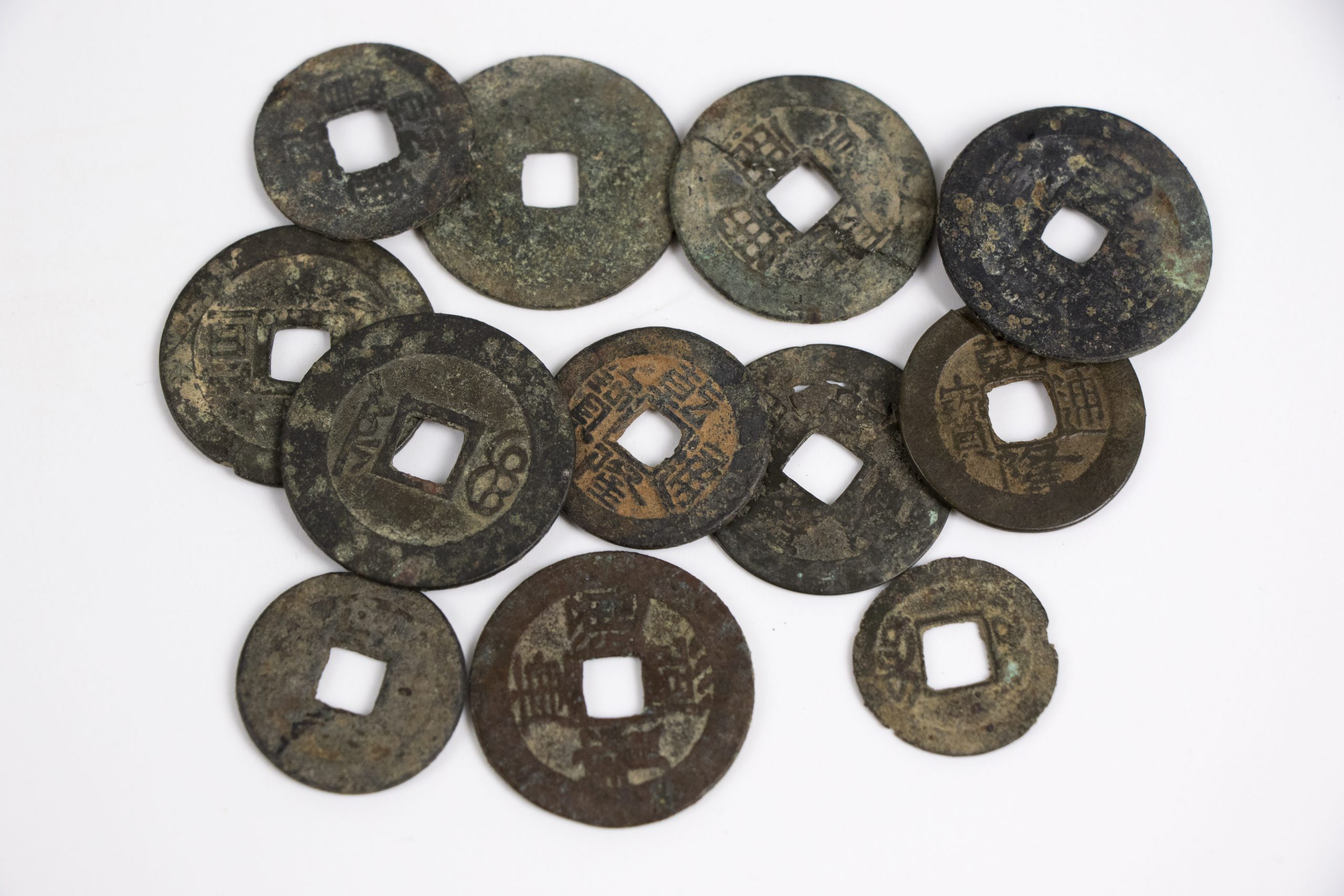 collection of circular coins with square cut-outs in the centre
