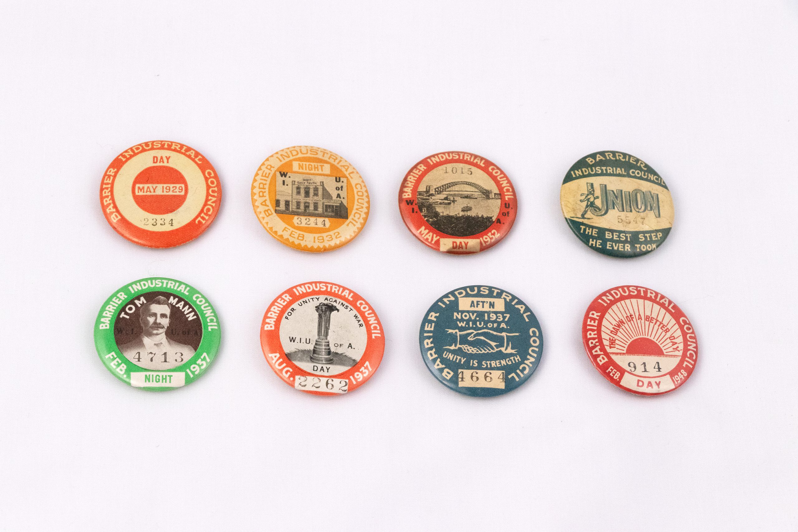 collection of eight multi-coloured, circular badges