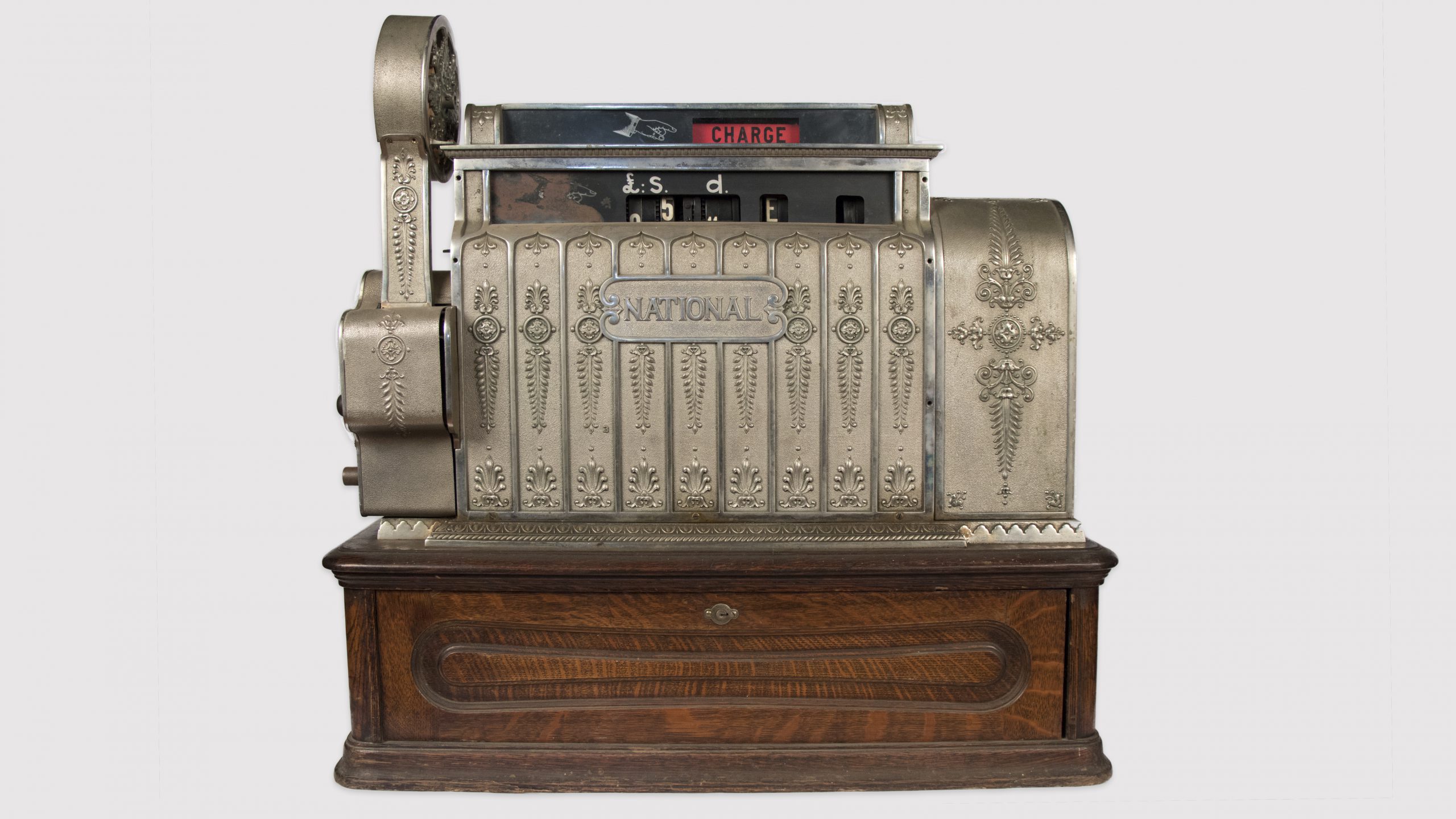 metal antique cash register on wooden base