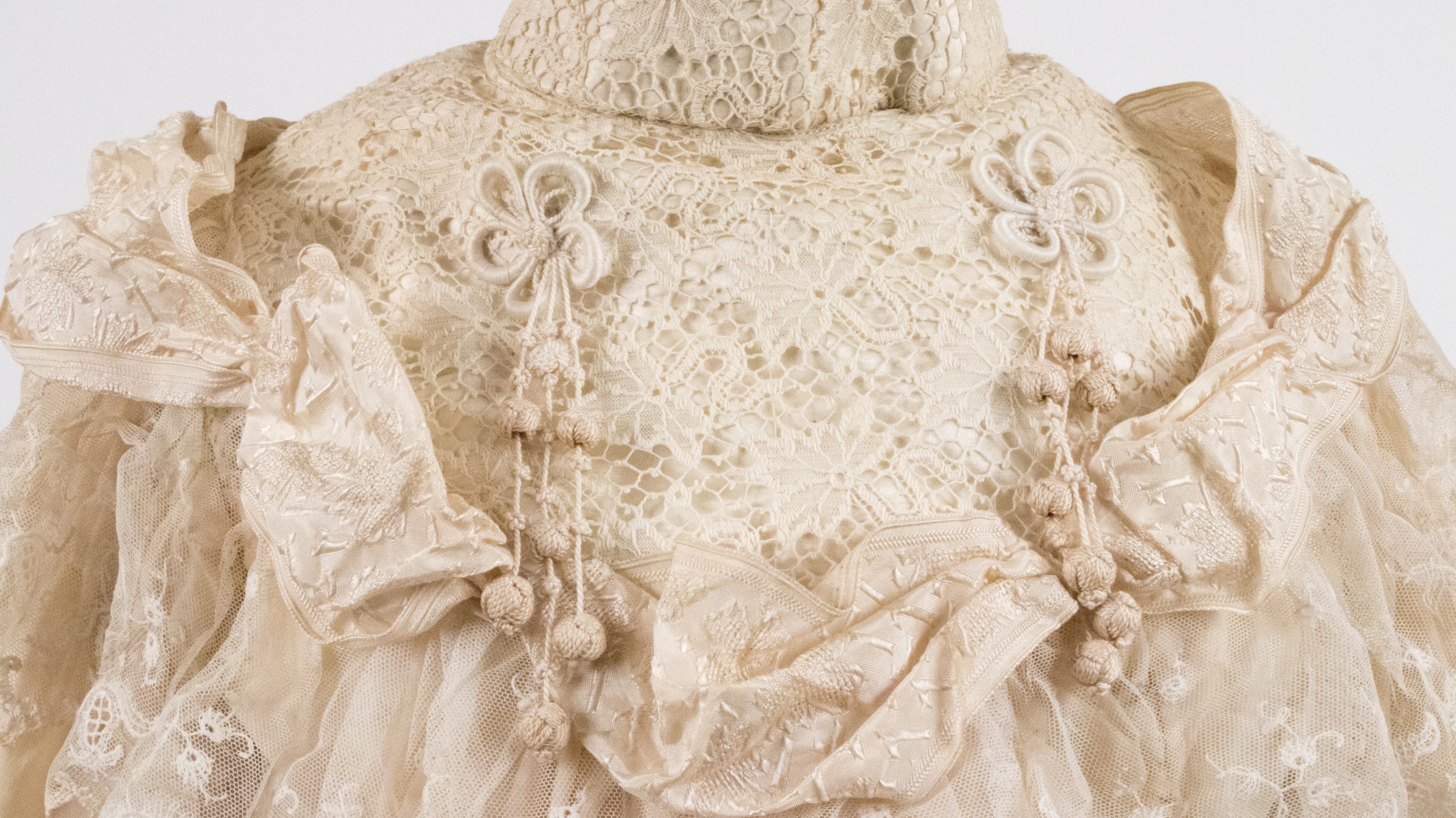 detailed, lacey wedding dress with floral patterning and decorative elements