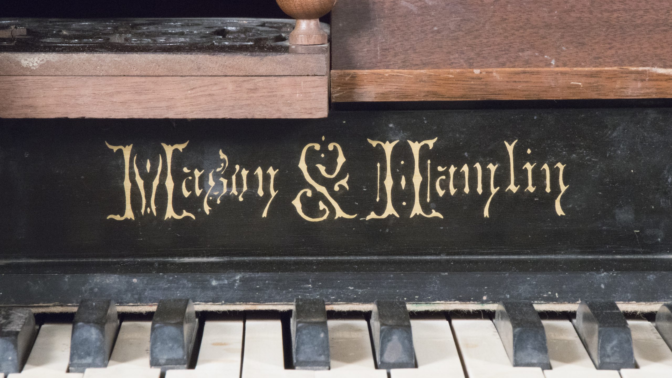 detail of lettering on organ which reads 'Mason & Mamlin'