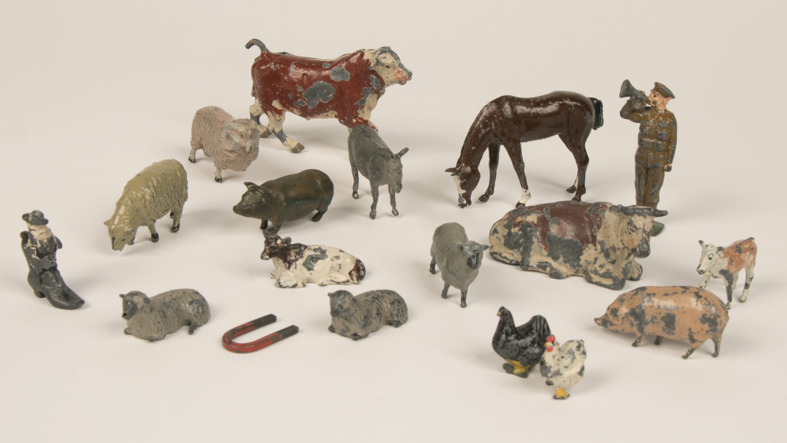 collection of slightly damaged toys of farm animals