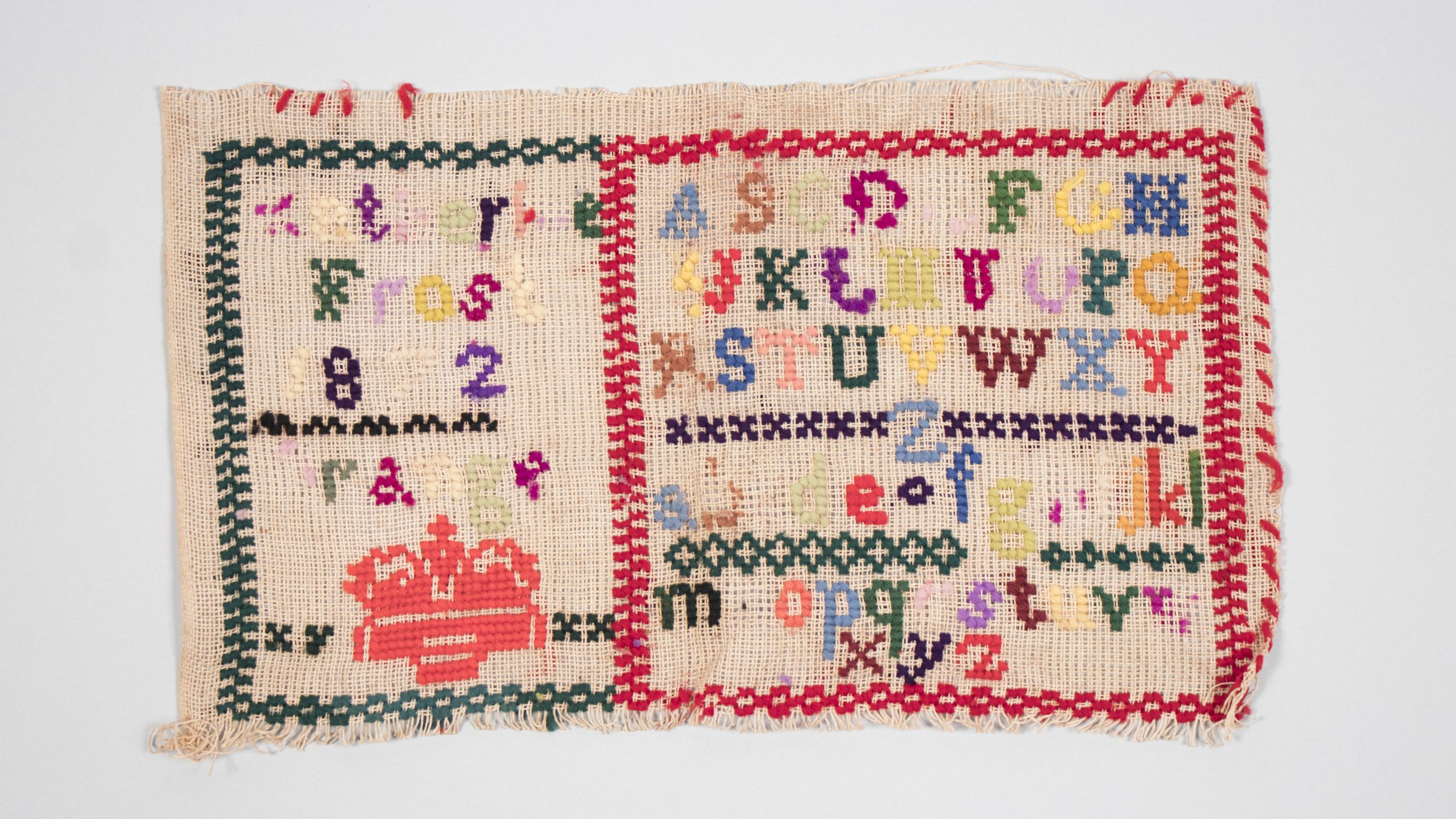 sampler with multicolour thread listing the alphabet in various cases