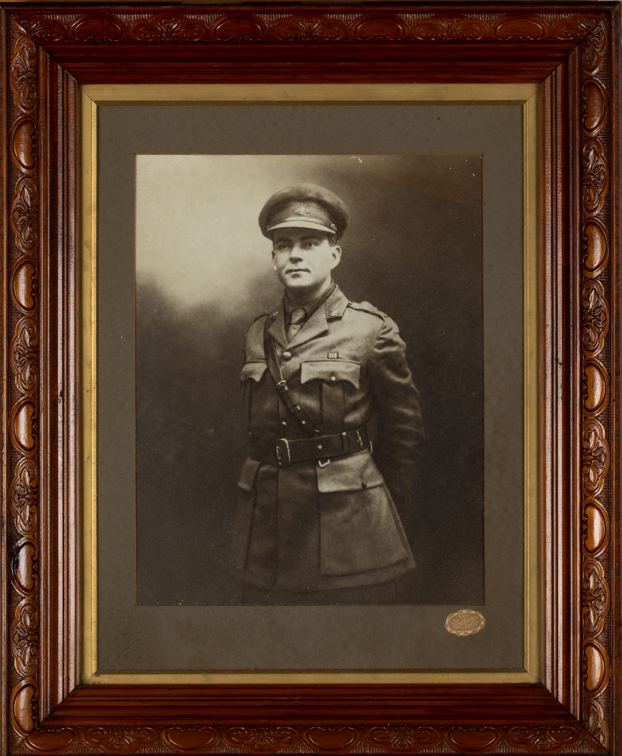 framed black and white portrait of a soldier with hands behind his back