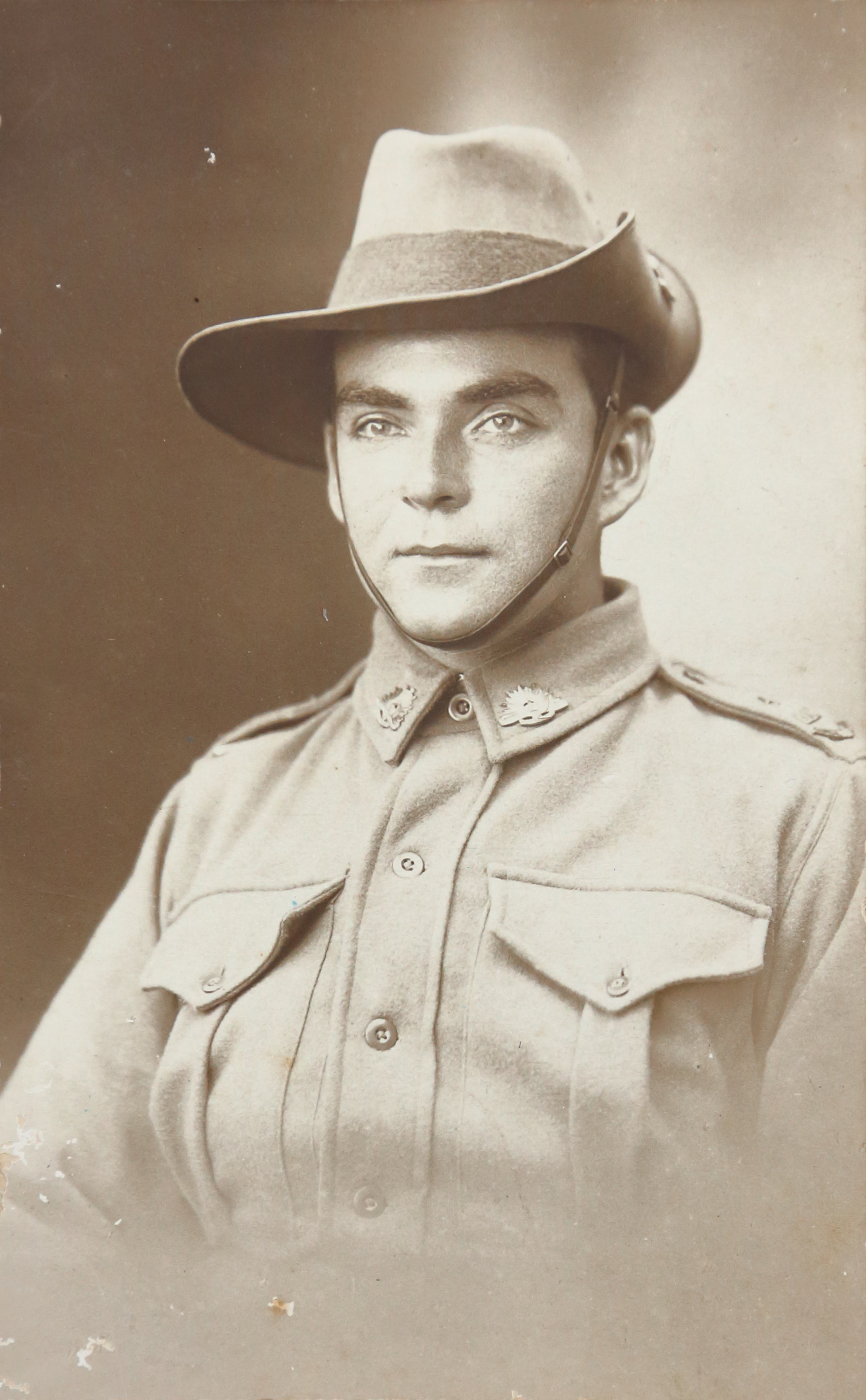 black and white portrait of a soldier, he wears a large hat with one brim pinned upwards, he has thick brown eyebrows