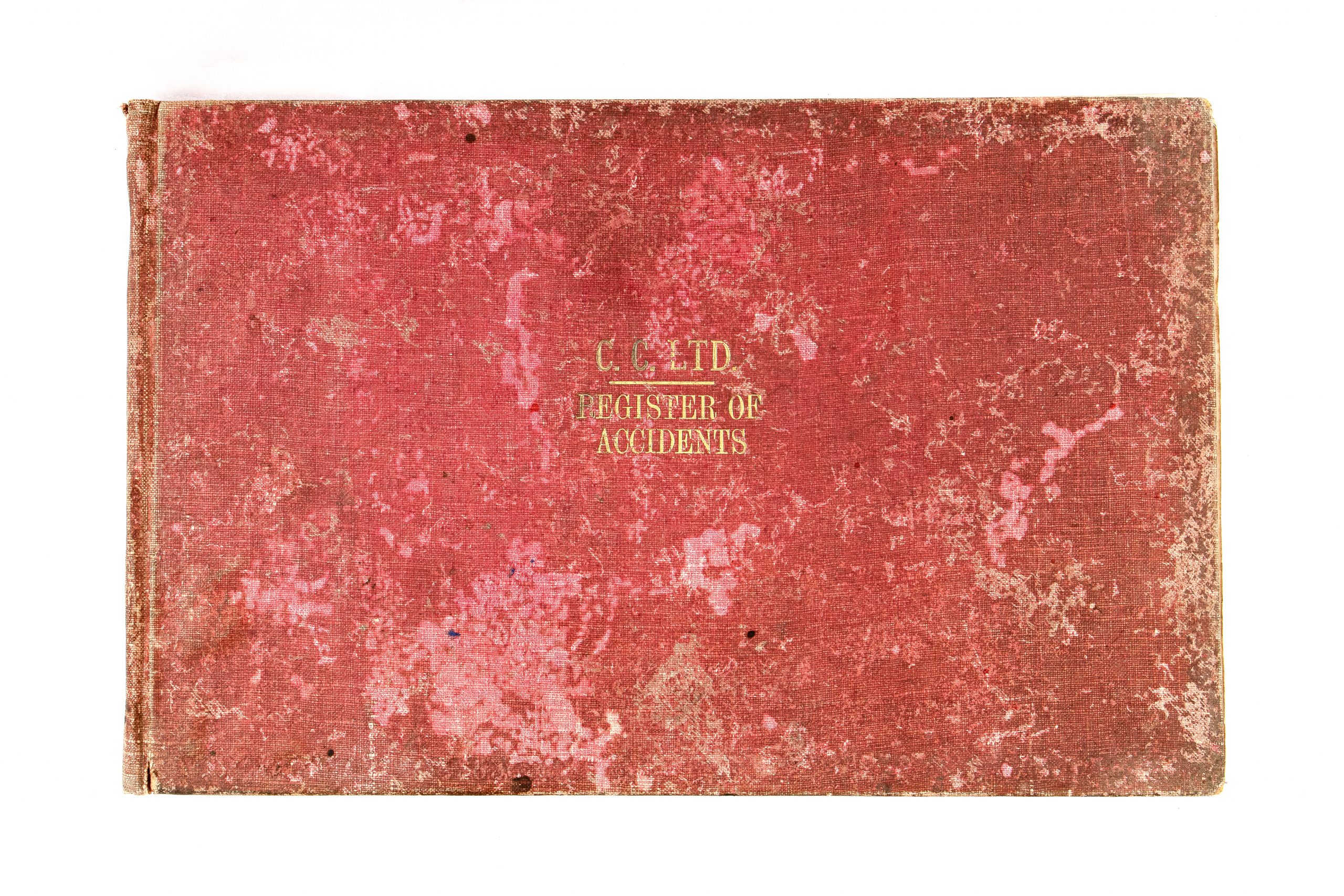 heavily tarnished red cover with gold lettering reading 'C.C.LTD. REGISTER OF ACCIDENTS'