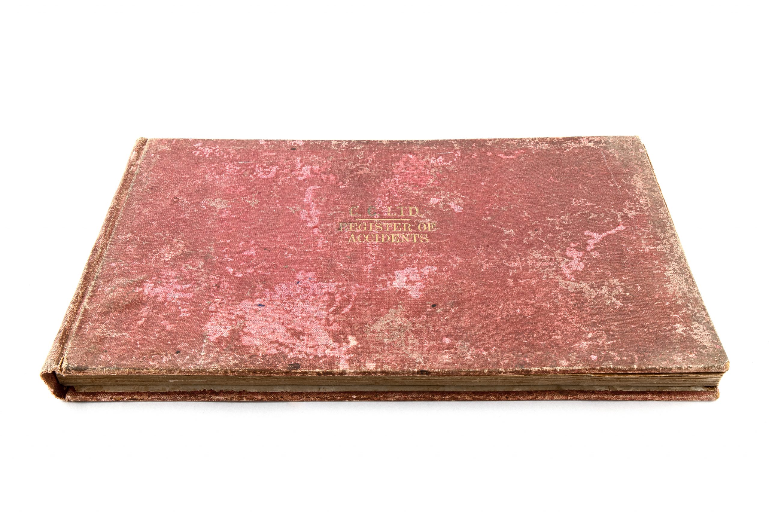 heavily tarnished red cover with gold lettering reading 'C.C.LTD. REGISTER OF ACCIDENTS'