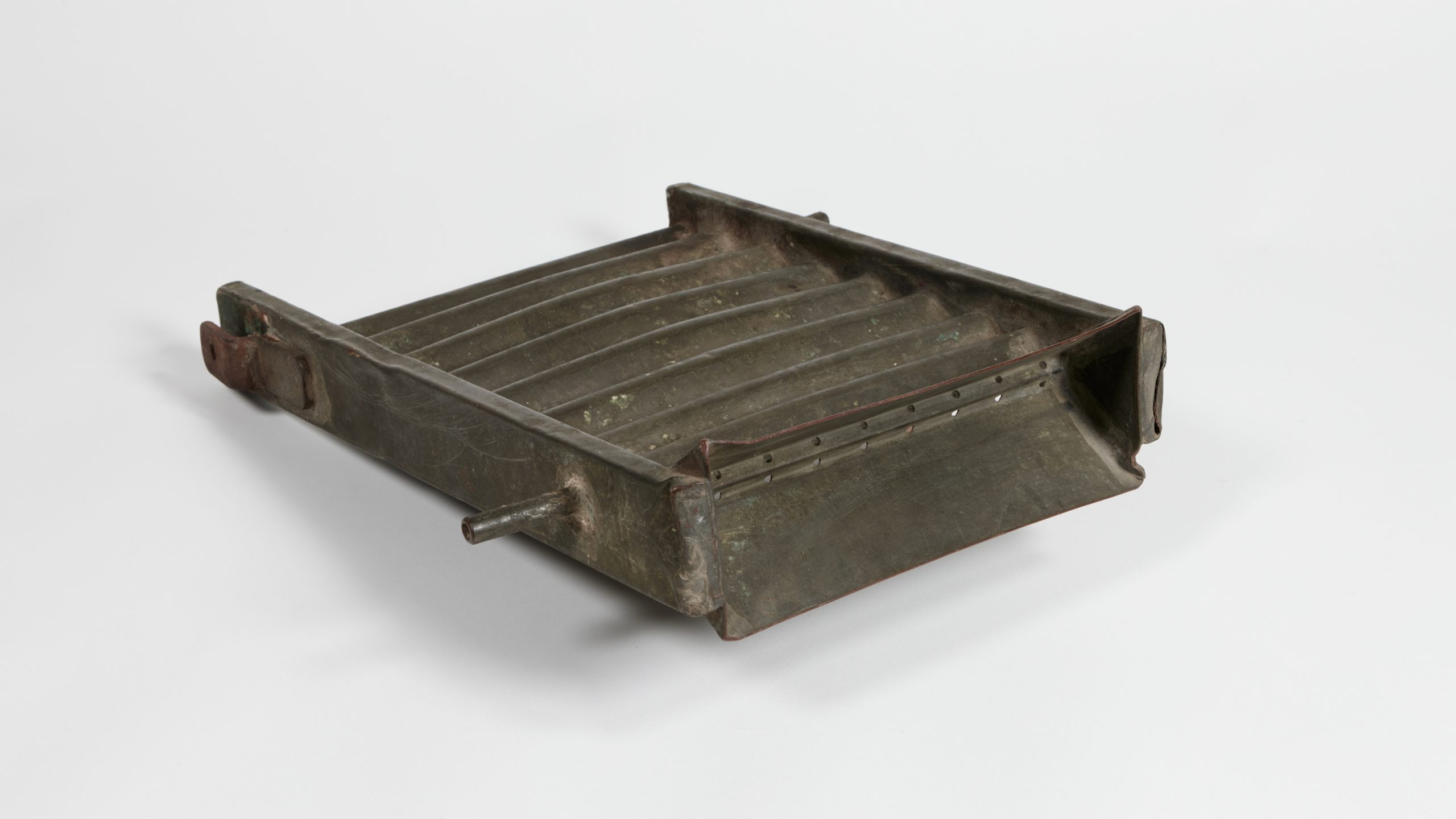 corrugated metal device with pins used for attaching